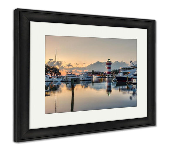 Framed Print, Hilton Head Island And Its Iconic Lighthouse Lit Up At Sunset With A Glass Like Framed Print Ashley Art Studio 